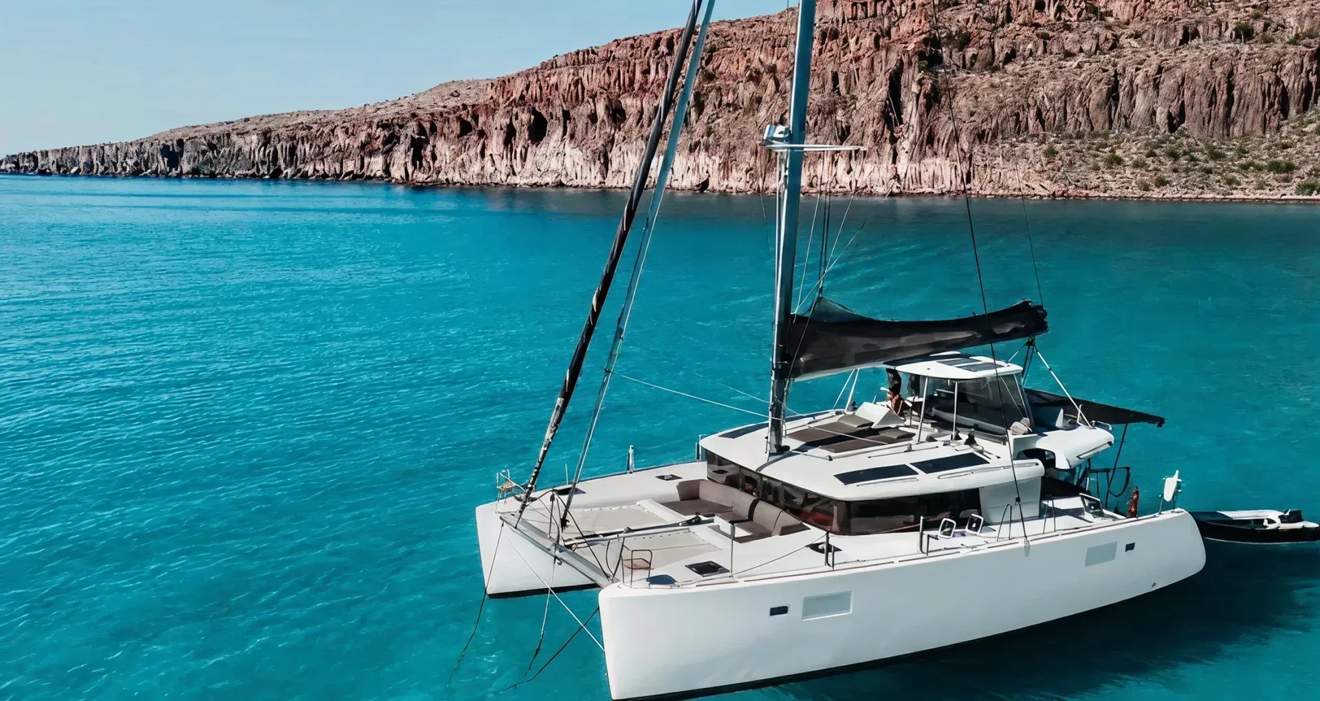 Catamaran on sea in front of island