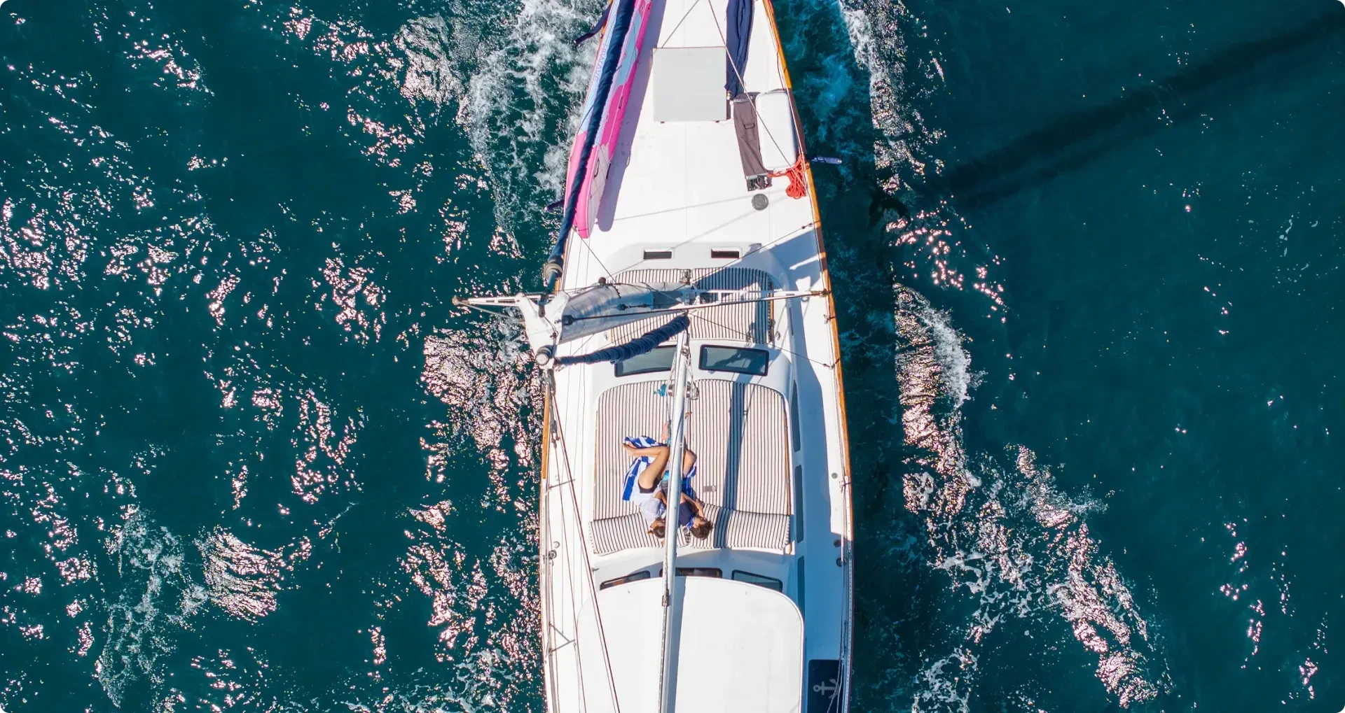 sailboat topdown drone view with couple on board